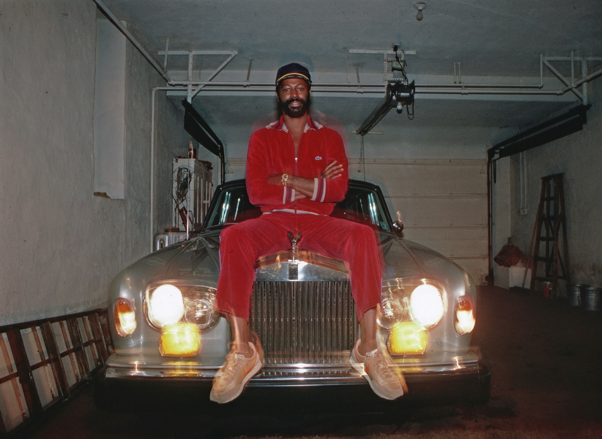 Teddy Pendergrass, on the hood of his Rolls-Royce and wearing a Lacoste velour track-suit, 1980. Photo by Lynn Goldsmith/Corbis/VCG via Getty Images.